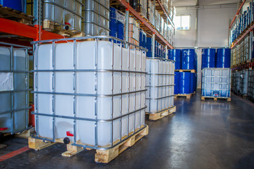 White plastic barrel. Barrel on a pallet with a metal frame. Shipment of chemicals. Plastic container for liquids. © Grispb