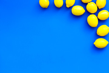 Ripe lemon fruit backround on blue table top view copy space