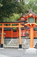 Beautiful famous red Fushimi Inari-taisha, a spiritual ancient buddhist shrine to worship and a religious and sightseeing attraction landmark in Kyoto Japan (Asia)