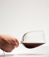 Hand hold horizontal red wine glass