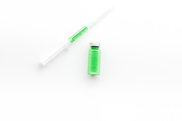 Fototapeta premium Syringe with colored drug. Injection concept on white background top view copy space