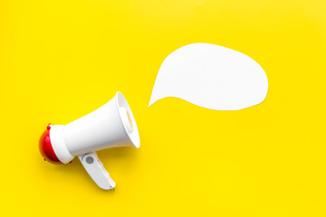 Statement concept. Megaphone near blank cloud for text on yellow background top view copy space...