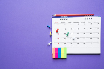 close up of calendar on purple background, planning for business meeting or travel planning concept
