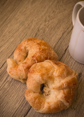Croissants pastry on the wooden table. The croissants is a bread product made of a layered yeast-leavened dough with butter rolled and folded several times in succession, then rolled into a sheet.
