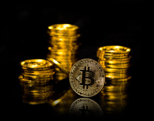 Bitcoin. Physical Bitcoin isolated on black background. Golden coin with bitcoin symbol isolated on black background with copy space. Digital currency