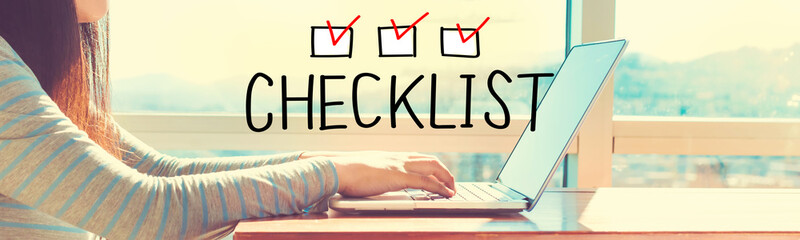 Checklist with woman working on a laptop in brightly lit room