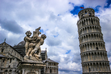 Fontana dei Putti and Leaning Tower of Pisa (Torre pendente di Pisa) in Piazza dei Miracoli (Square...