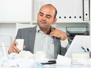 Busy businessman in shirt worrying at the computer