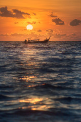 Seascape of sunset with cloudy sky and Longtail