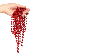 Cristmas decoration, ceramic red ball chain in hand isolated on white background. New Year object, Mardi Gras beads. copy space, template