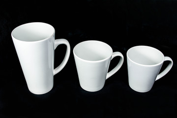 insulated unprinted cups for sublimation of different shapes, colors and designs designer on a black background isolated