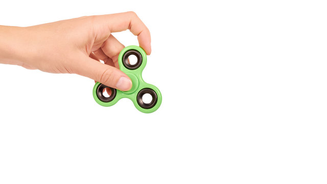 green fidget spinner in hand isolated on white background. copy space, template - Powered by Adobe