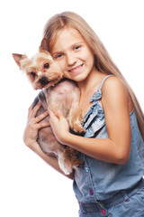 Happy girl holding her lovely yorkshire terrier dog. Isolated on white