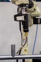 Industrial robot is in teaching mode it is learning new program in  car factory
