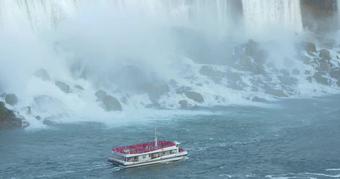 Boat with tourists navigating near the Niagara Falls, Canada