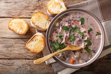 Creamy soup of wild rice, chicken close-up in a bowl. horizontal top view