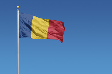 Flag of Romania in front of a clear blue sky