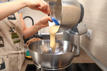 Woman making dough for cake