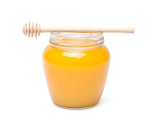 honey dipper and honey in jar on white background