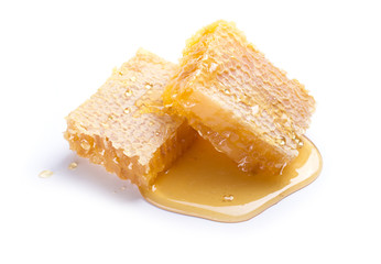 Honeycomb with honey dipper isolated on white background