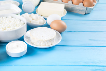 dairy products on blue wooden background, top view