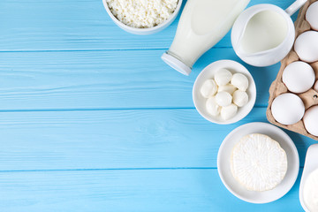dairy products on blue wooden background, top view