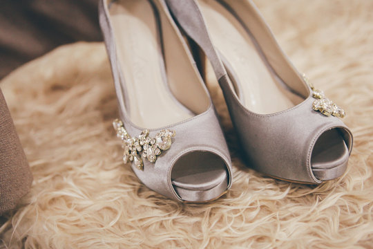 Bride wedding details - wedding shoes. Selective focus. Toned image. Copy space.