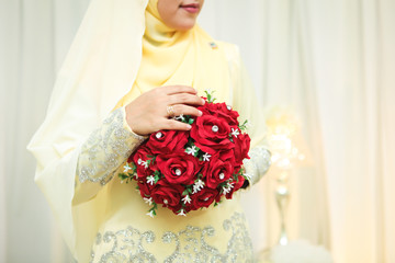 Wedding flowers ,Woman holding red bouquet with her hands on wedding day. Selective focus.