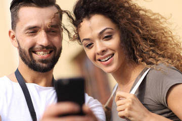 Young couple visiting city in summertime and looking photos