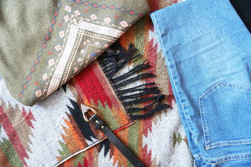 Fashion background of patterned fabrics in boho style. Top view.