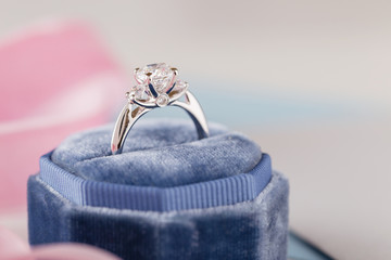 White golden wedding ring with diamonds in blue vintage velvet box