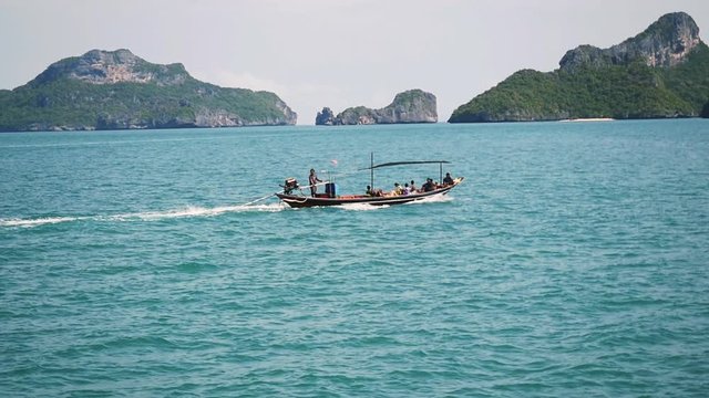 Speedboat sails with tourists into the sea between islands. Travel destinations. slow motion. 1920x1080,