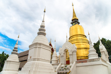 Naklejka premium The golden buddhist pagoda in Wat Suan Dok this important monastery enshrines one half of a sacred Buddha relics in Chiang Mai province of Thailand.