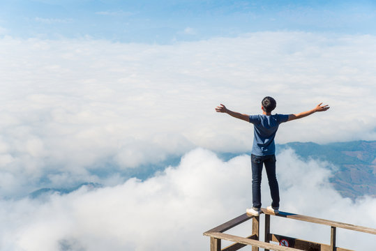 Young man dare to standing on the wooden terraces.