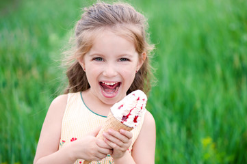Beautiful little girl eats ice-cream