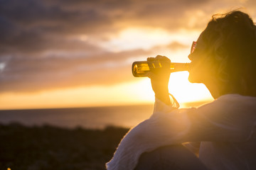 Fototapeta na wymiar nice woman drink a beer in the sunset