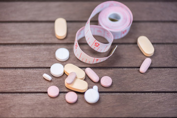 Measuring tape and pills for dieting concept