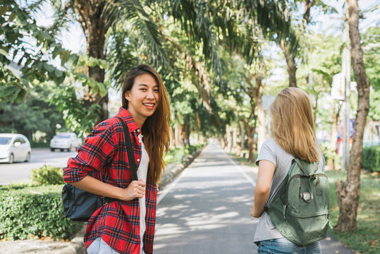 Couple of young Asian women standing along the street enjoying their city lifestyle on weekend waiting for outdoor activity. Young women and their city lifestyle. city lifestyle and outdoor concept.