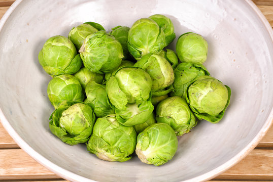Fresh raw rustic brussels sprouts in a ceramic bowl