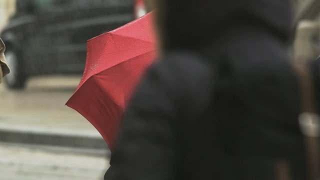 Woman With a Big Red Umbrella Waiting at the Bus Stop