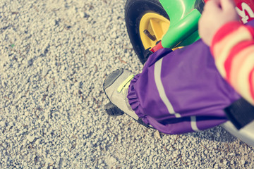 Closeup of child feet pushing a pedal on bike.