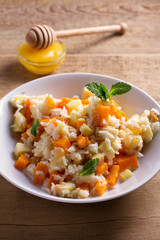 Healthy food: rice porridge with pumpkin, apples and raisins. Vegetarian or diet dish of rice and pumpkin good for breakfast