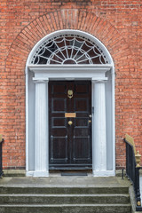 Black classic door in Dublin, example of georgian typical architecture of Dublin, Ireland