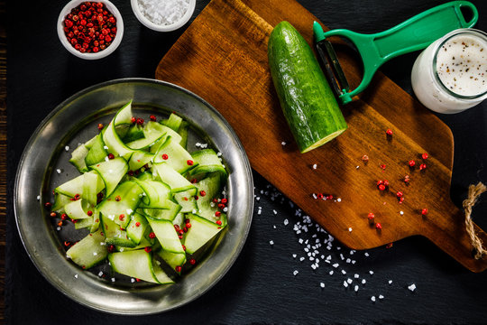 Fresh cucumber on cutting board