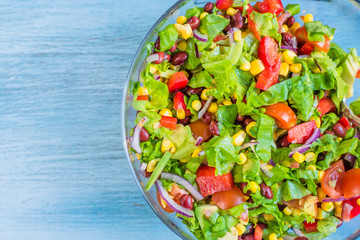 Traditional vegetarian American Southwest Salad on a glass bowl and rustic background - copy space for a recipe