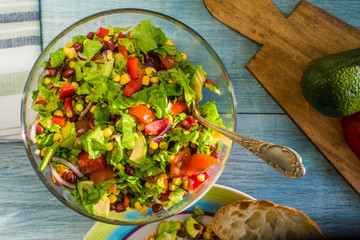 Traditional Vegetarian American Southwest Salad with vegetables, beans and corn on a rustic background