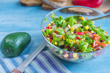 Traditional Vegetarian American Southwest Salad with vegetables, beans and corn on a rustic background
