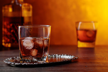 Glass of scotch whiskey and natural ice .