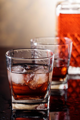 Glass of scotch whiskey with natural ice .