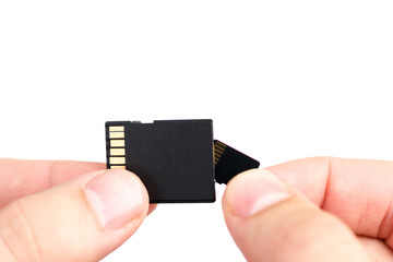 Small Flash card in hand isolated on white background.
